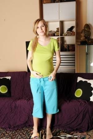 Smiley pregnant amateur with puffy nipples and hairy gash getting naked on www.girlzfan.com