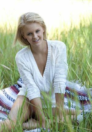 Blue eyed blonde teen Marie casts off her clothes to pose nude in a field on www.girlzfan.com