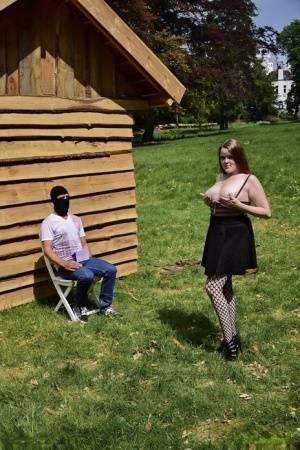 Natural redhead masturbates on a lawn before teasing a masked man on girlzfan.com